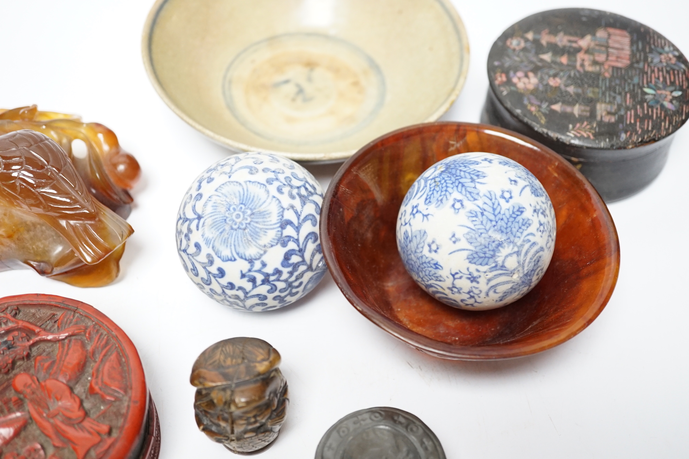 Eleven Chinese or Japanese items including; a bowl, a red lacquer box, an agate carving of a bird group, a carved hardstone lion tortoise, mother of pearl counters, etc.